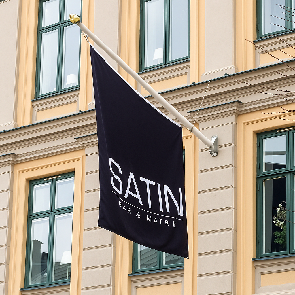 Fasadflaggstång med svart flagga som sitter på ett gammalt hus